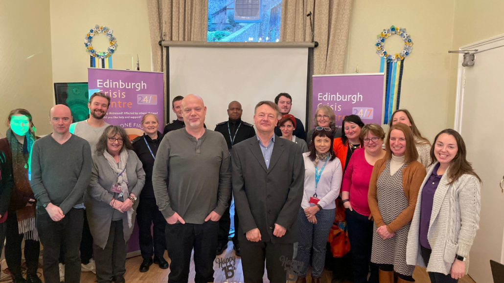 Photo showing the team of staff and volunteers gathered at the 15th anniversary event for the Edinburgh Crisis Centre.