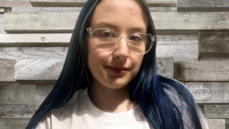 image shows a close up head and shoulders shot of rachel smiling to camera